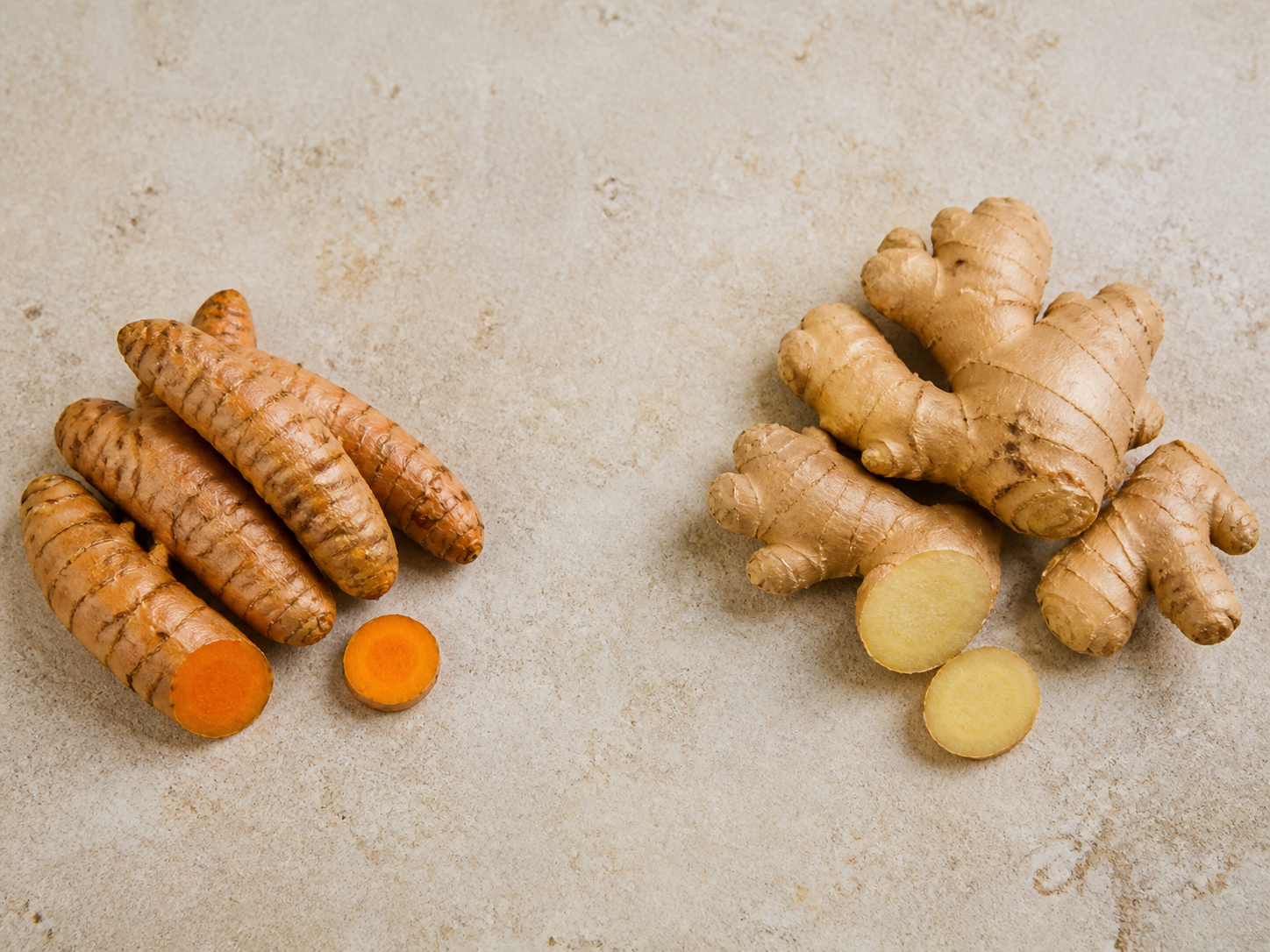 Turmeric root and ginger root side by side